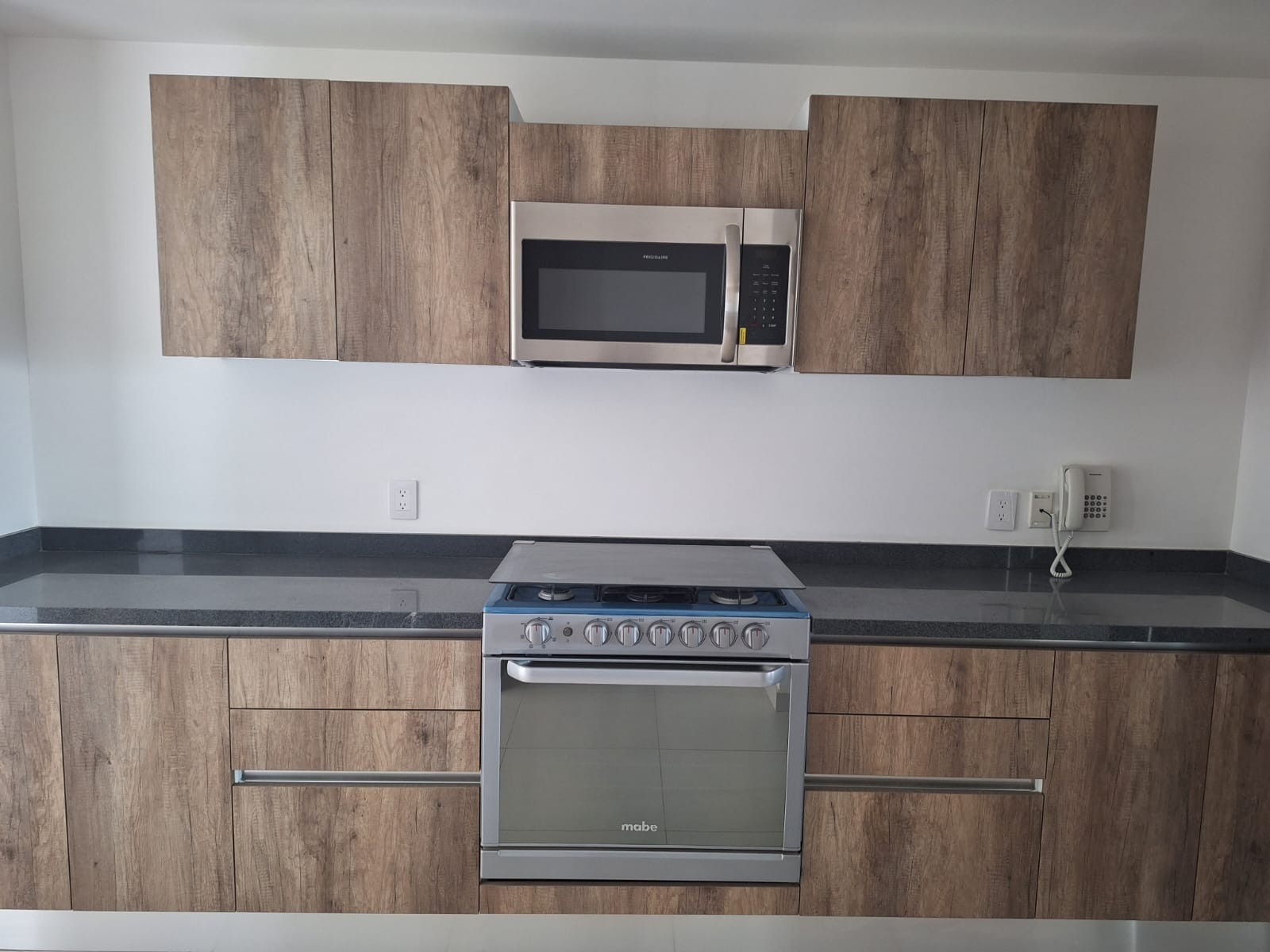 Cocina con gabinetes de madera · FIVE Bosque Real · 163 m²